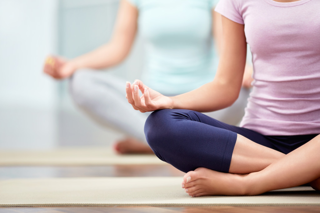 Young people do yoga indoors